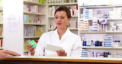 Customer giving prescriptions of medicine to pharmacist