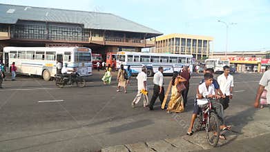 GALLE, SRI LANKA - MARCH 7, 2014: People and buses in front of central bus station. Buses are the main means of transport in the