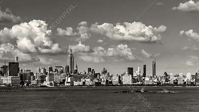 Manhattan Midtown West skyscrapers and Hudson River with passing clouds in Black & White. New York CIty