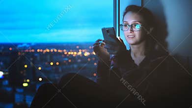 Girl Looking at Smartphone on City Background