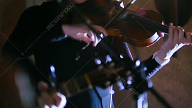 Rock band - Woman playing the violin at rock concert