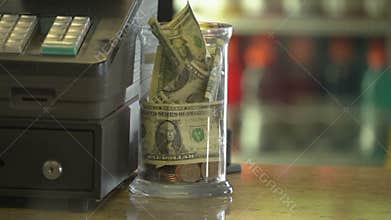 A full tip jar near register