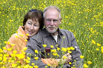 Senior couple in a buttercup field
