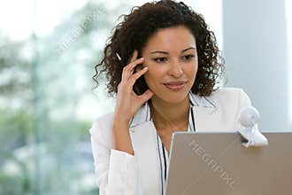 Attractive business woman working on laptop