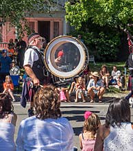 Man in kilts plays a drum in parade