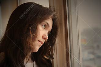 Depressed looking out window