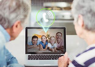 Senior couple having video call with family on laptop