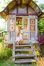 Pretty blonde woman and antique gypsy caravan 2
