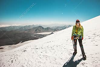 Woman alpinist climbing in mountains