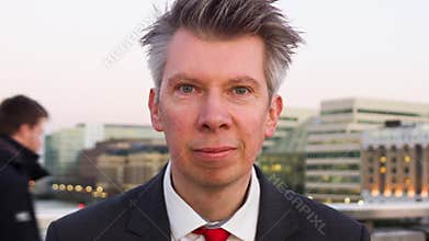 Businessman standing still looking at the camera