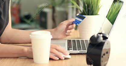 Online shopping. Young caucasian hands buying goods from the internet on his smartphone with his credit card.