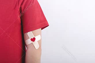 Child with a heart drawn on his arm. Blood donation concept