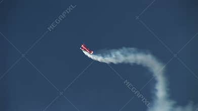 Biplane doing aerobatics in blue sky