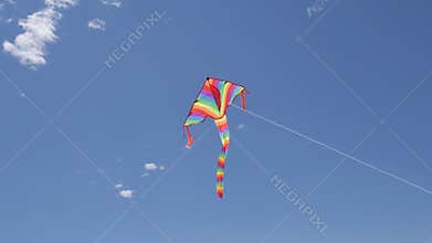 Kids kite dancing in the wind with cloudy sky