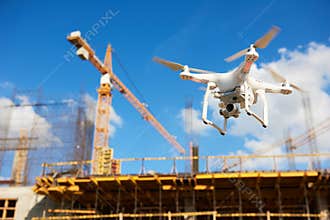 Drone over construction site. video surveillance or industrial inspection