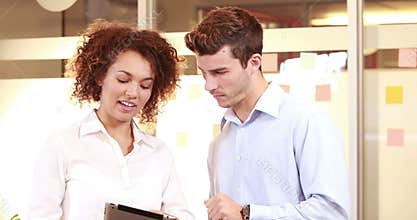 Smiling casual business worker using tablet computer
