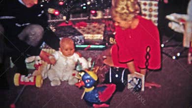 TOLEDO, OHIO 1968: Mom dad baby play new Christmas gift toy