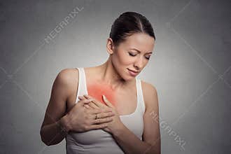 Young woman with breast pain touching chest