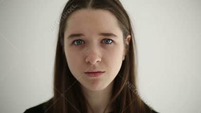 Unhappy sad teenage girl isolated at white background