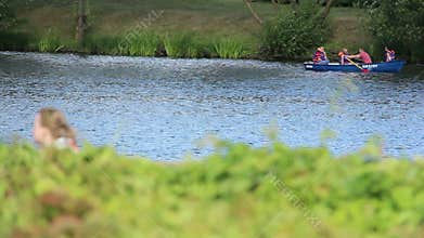 People are floating on a boat on the river