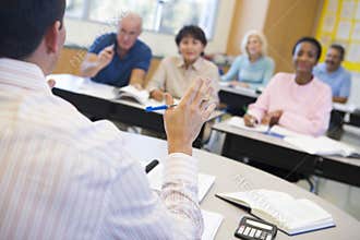 Mature students and their teacher in a classroom