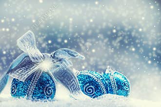Christmas. Christmas blue balls and silver ribbon snow and space abstract background.