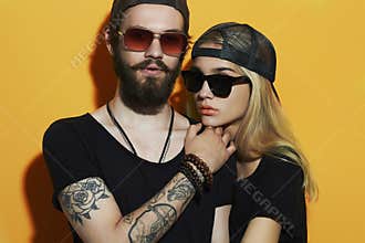Fashion beautiful couple together. Tattoo Hipster boy and girl