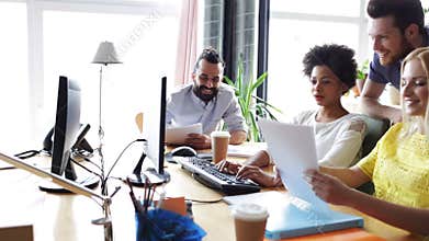Happy creative team with computers in office