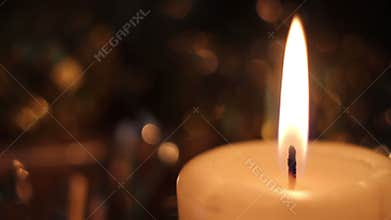 Burning candle in the dark. Ignition