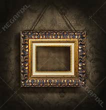 Gold picture frame on antique wallpaper