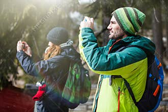 Hiking and photography. Two people taking a picture.