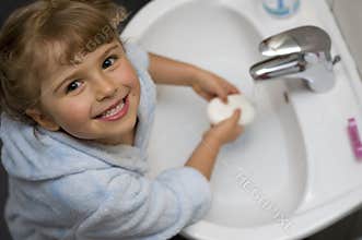 Cute girl washing hands