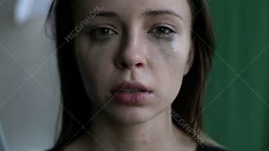 Close up of a scared and crying woman with smeared make up