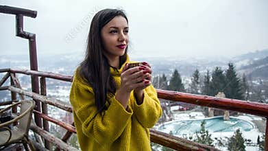 Beautiful young girl enjoy a hot cup of coffee