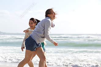 Candid women laughing at the beach