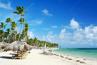 Caribbean resort beach with umbrellas and chairs