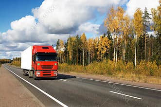 Red truck on autumn highway