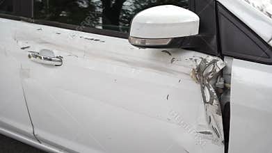 White car after an accident. broken, crumpled door