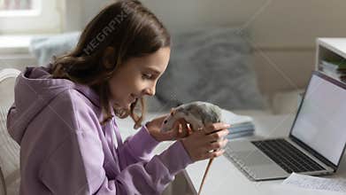 Loving teen girl play with domesticated mouse