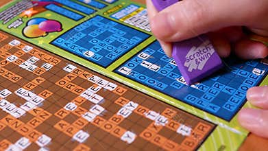 Motion of man scratching lottery ticket with 4k resolution.