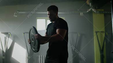 Handsome Man Do Abs Workout With Additional Weight .