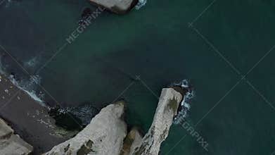 Overhead Top Down Birds Eye Aerial View of Etretat Cliffs in France with Waves and Birds Flying by