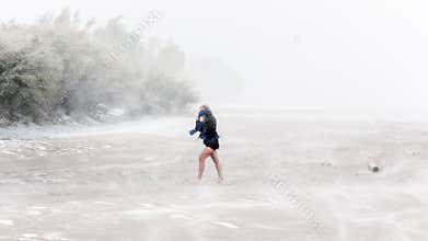 Woman walking in a blizzard