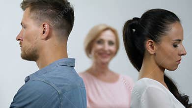 Young family couple standing back to back pleased mother-in-law smiling, breakup