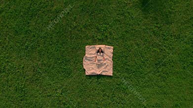 Top view brunette sleep on green grass