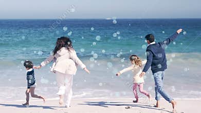 Moving spots of white light with family on beach