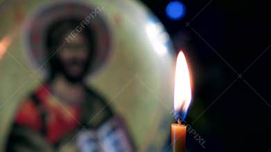 Burning candle at the Orthodox Christian icon.