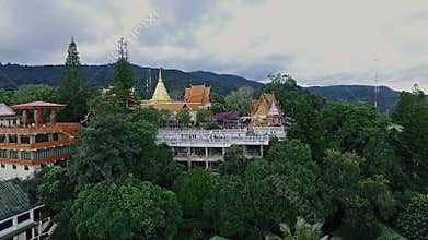 Aerial of Golden Buddhist Temple on Top of Mountain in Chiang Mai, Doi Suthep, Northern Thailand 04