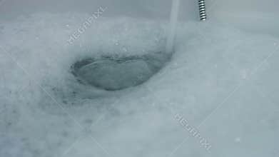 Pouring bathtub with water