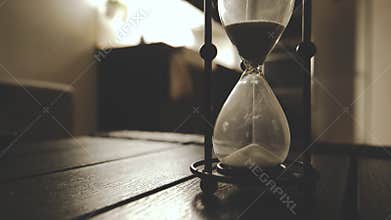 Old Fashioned Hourglass Counting Classic Sand Clock  In Dark Night Atmosphere Cinematic Warm Feel Time Goes Closeup